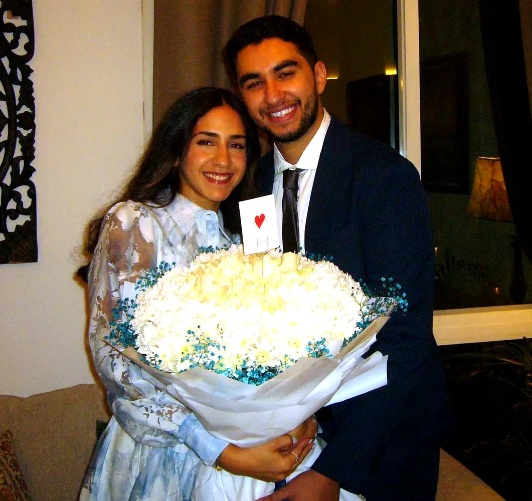 Mariam and Ryan smiling together with flowers